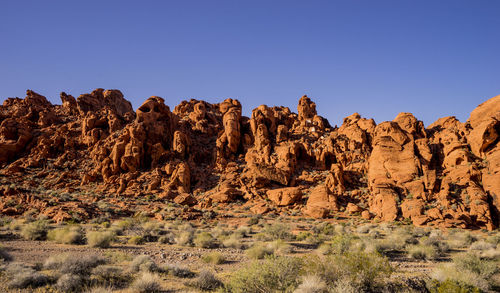 Rock formations in desert against clear sky