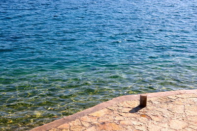 High angle view of rock by sea