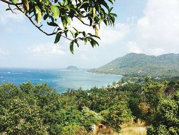 Scenic view of sea and mountains against sky