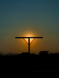 Silhouette built structure against sky during sunset