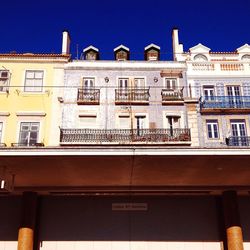 Low angle view of building against clear blue sky