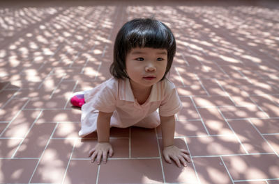 High angle view of girl sitting on floor