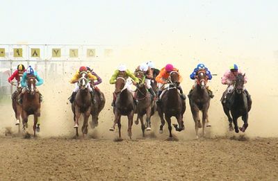 Group of people running on field against sky