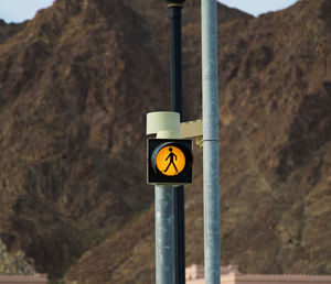 Road sign against rocky mountains