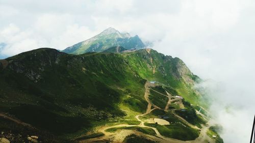 Scenic view of mountains against cloudy sky