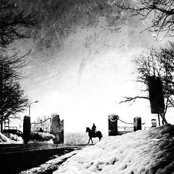 Silhouette people on snow against sky during winter
