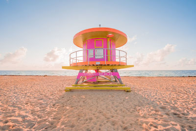 Lifeguard hut on beach against sky