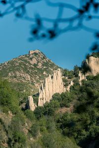 Scenic view of rocky mountains against blue sky