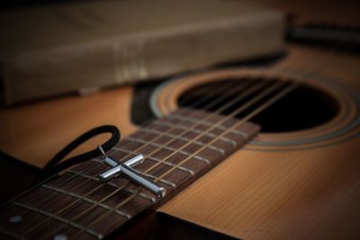 Close-up of cross on guitar 