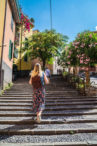 Rear view of woman walking on staircase