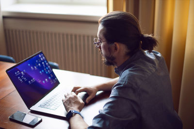 Young woman using laptop at home