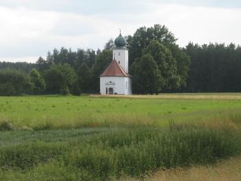 Built structure on field against sky