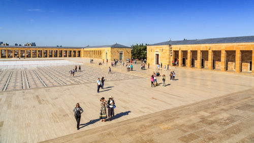 People at town square against clear sky