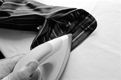 Close-up of person ironing shirt