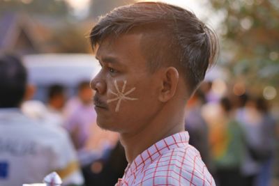 Side view of man with painted cheek