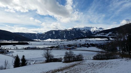 Scenic view of snow covered mountains against sky