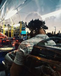 Man seen through glass of car on street