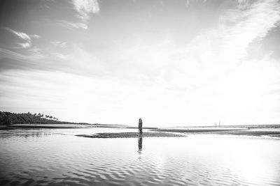 Man standing on beach against sky