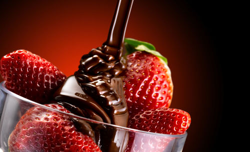 Close-up of strawberry over black background