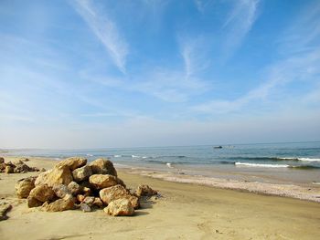 Rocks on beach against sky
