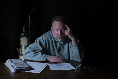 Portrait of a man sitting on table