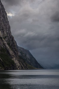 Scenic view of fjord and mountain against sky