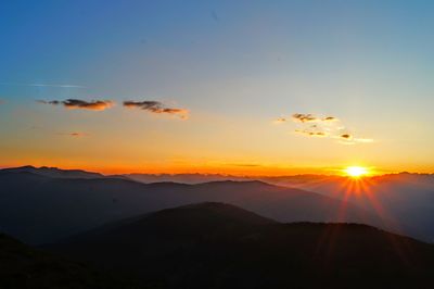 Scenic view of silhouette mountains against sky during sunset