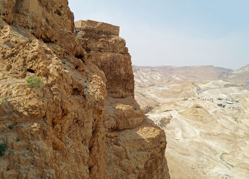 Rock formations on landscape against sky