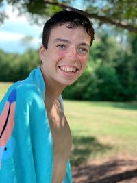 Portrait of smiling boy on field