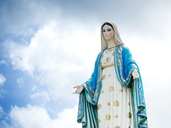 Low angle view of statue against blue sky