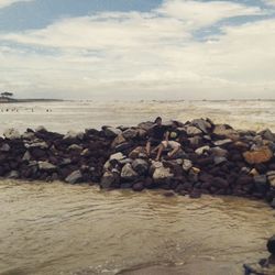 Scenic view of sea against cloudy sky