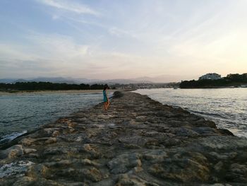 Scenic view of sea against cloudy sky