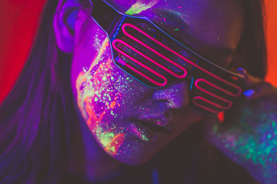 Close-up of woman wearing multi colored light painting