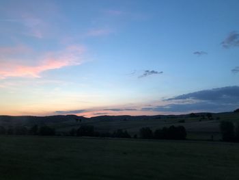 Scenic view of field against sky during sunset