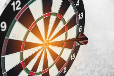 Close-up of dart on bulls eye