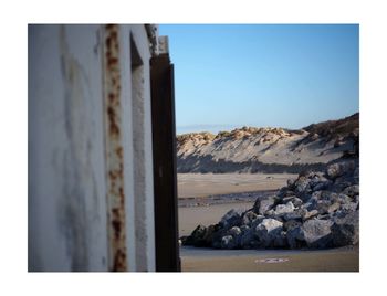 Scenic view of beach against clear sky