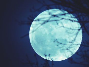 Low angle view of moon against blue sky