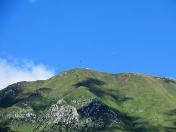 Scenic view of mountains against clear blue sky