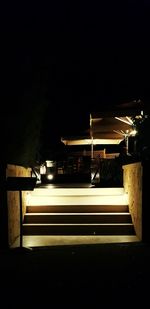 Illuminated railroad station platform at night