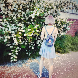 Woman standing by plants