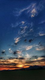 Scenic view of field against sky at sunset