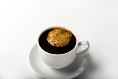 Close-up of coffee cup against white background