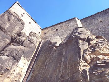 Low angle view of old building against blue sky