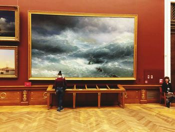 Full length of woman standing against cloudy sky