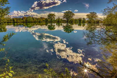 Reflection of trees in lake against sky