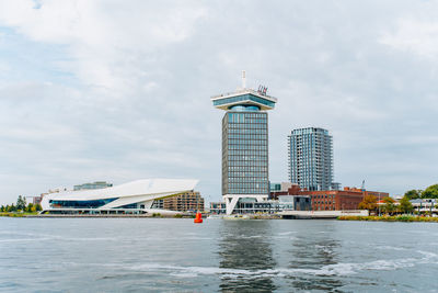 Lighthouse on building against cloudy sky