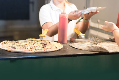 Midsection of man preparing food in restaurant