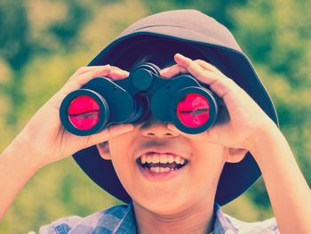 Close-up of boy looking through binoculars