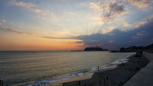 Scenic view of beach against sky during sunset