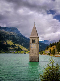 Church by building against sky